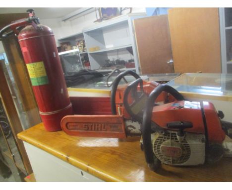 A Stihl chainsaw, together with an Husqvarna chainsaw, and a vintage Minimax fire extinguisher 