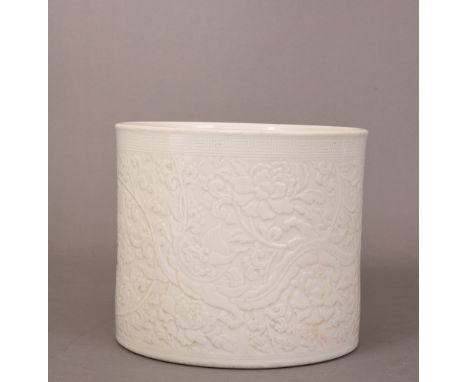 Chinese white-glazed cylindrical brush pot, incised with two dragon amidst scrolling leafy flowers, Kangxi six-character mark