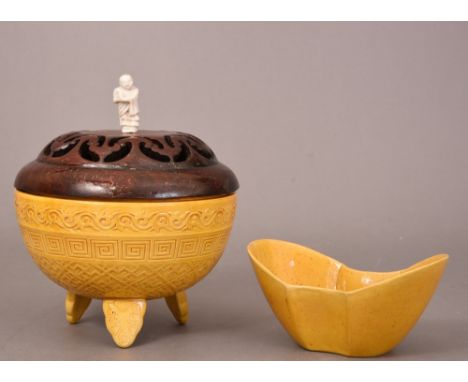 C18th Chinese yellow-glazed ritual tripod vessel and a pierced wood cover with a Luohan finial, 16.4cm diam; together with a 