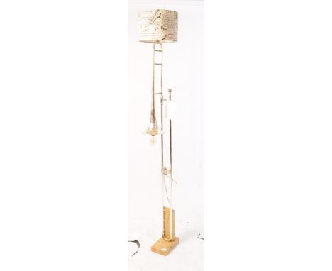 A vintage mid century crica 1970s trombone floor standing standard lamp. On a wooden plinth base with silver metal trombone f