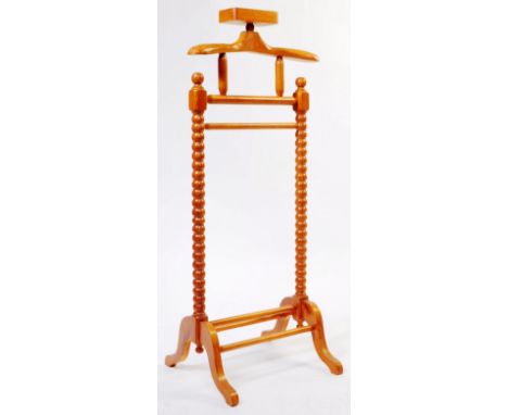 


A vintage 20th century mahogany gentlemen's valet clothes horse stand. With jacket hanger to top and button pot. Raised on
