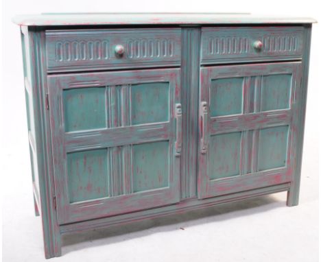 Ercol - A 20th Century vintage painted Ercol sideboard in teal colourway. With two drawers above cupboard doors with panel de