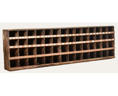 A retro 20th century wooden bespoke / custom made haberdashery tools storage cabinet. The cabinet having 56 squared compartme
