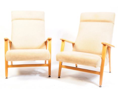 Manner of Ercol Furniture - A set / pair of mid century easy chairs / armchairs. Raised on blond wood tapering angle set legs
