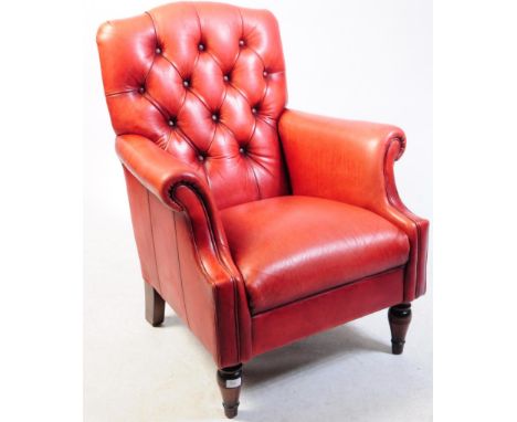 A red leather Chesterfield Queen Anne revival armchair. Upholstered in red leather with button backing, barrel arms and raise