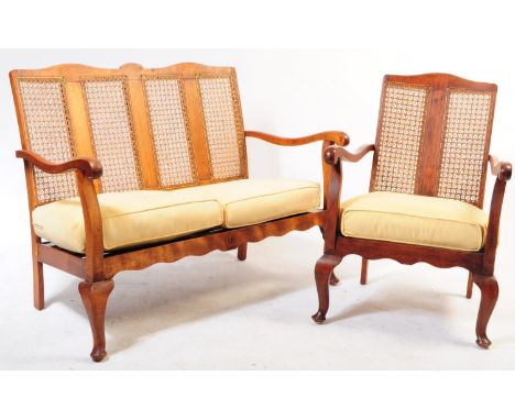 A 1930s Queen Anne revival walnut bergere suite. The suite to include 2 armchairs and a 2 seat sofa settee. Caned back rests 