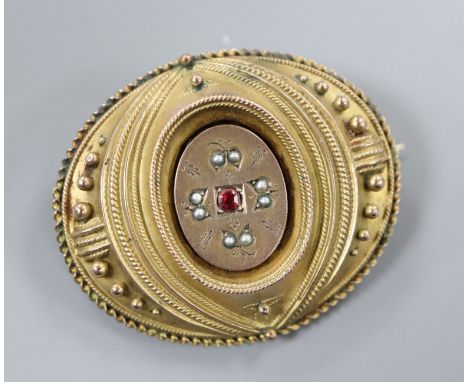 A Victorian yellow metal seed pearl and ruby set oval brooch, with glazed back, 42mm.