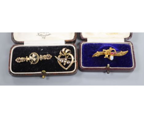 Three assorted early 20th century 15ct and gem set bar brooches including white opal and ruby, largest 42mm.