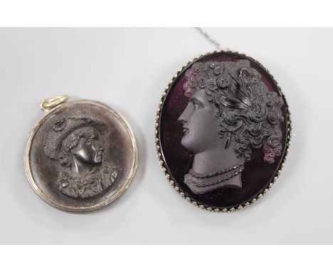 A metal mounted amethyst paste cameo carved with the bust of a lady to dexter and a tortoiseshell cameo, largest 58mm.