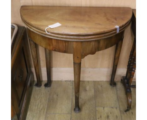 An 18th century mahogany triple folding tea / card table W.75cm