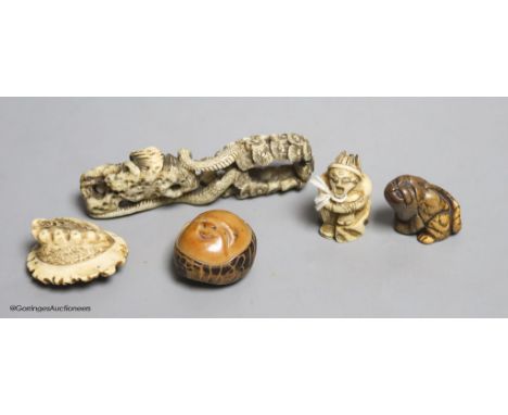   Two Japanese stag antler netsuke, a stained ivory tiger netsuke, a walrus ivory carving and a nut mask netsuke
