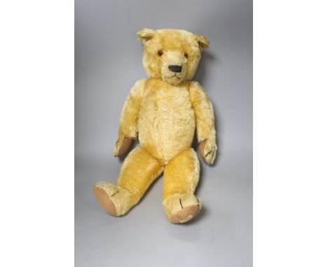   An early 20th century Chad Valley blonde plush teddy bear, length 58cm