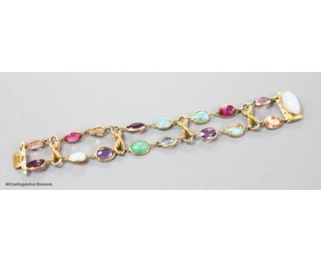   An early 20th century yellow metal and multi gem set bracelet, including white opal, turquoise, amethyst etc, 17cm, gross w