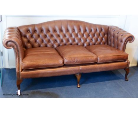   A George III style buttoned tan leather camel back sofa, 210 cm wideProvenance - a country estate near Rye, Sussex