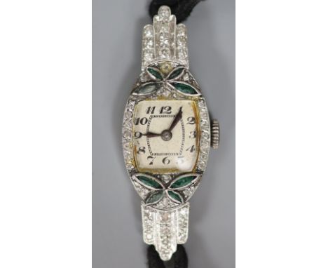   A lady's 1940's/1950's white metal (stamped platinum), emerald? and diamond set cocktail watch, on fabric strap, gross weig