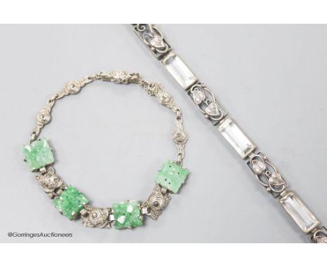   A white metal and carved jade set bracelet and one other bracelet.