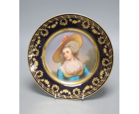   A Vienna style porcelain plate, c.1900, painted with a portrait of a lady wearing a hat, signed Weigel, diameter 25.5cm