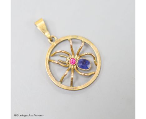   A 9ct, sapphire and ruby set circular spider pendant, 19mm, gross weight 1.9 grams.