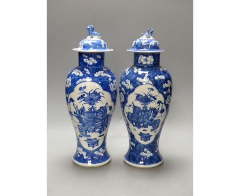   A pair of 19th century Chinese blue and white prunus vases and covers, height 38cm, a Kangxi marks