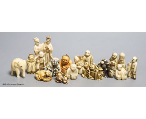   Fourteen Japanese ivory netsuke, a Chinese ivory group and elephant figure, all early 20th century