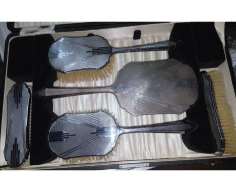 An Art Deco silver back 5 piece dressing table set, engine turned, Birmingham 1934, in original box (4 pieces chromium plated