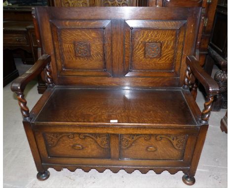 A early 20th century oak monk's bench with box seat and barley twist columns