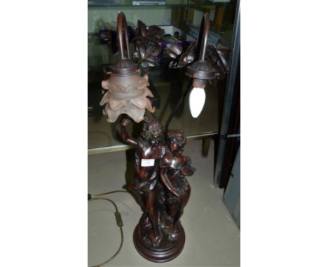 An Art Nouveau style large bronzed table lamp in the form of a young couple
