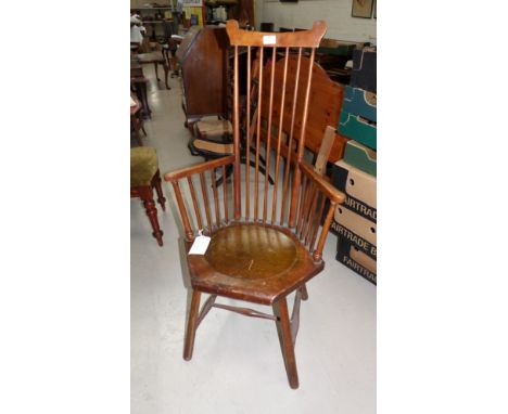 A Liberty style Arts & Crafts stick back armchair with hexagonal seat and peg legs 