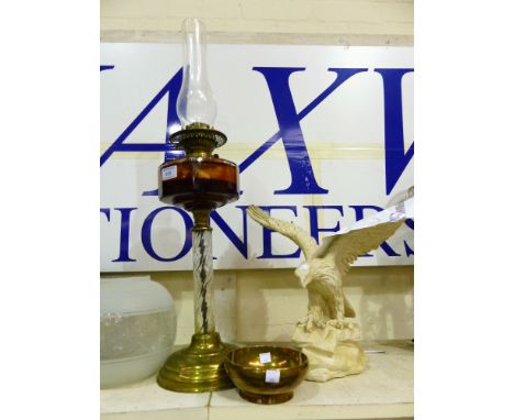 A 19th century oil lamp with twisted glass column, brass base, amber reservoir and shade; a heavy brass bowl; a plaster model