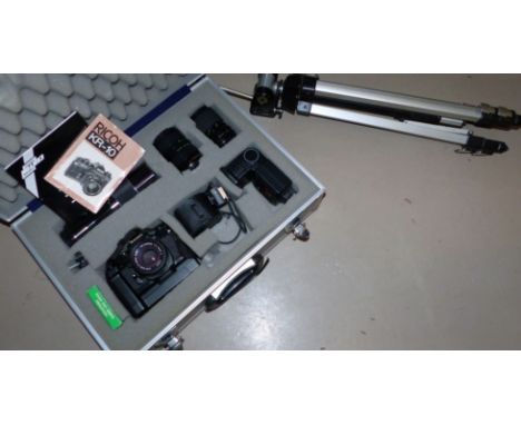 A Ricoh camera and lenses; etc., in fitted metal box, with tripod