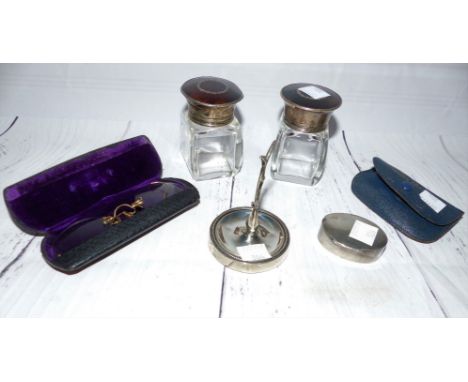 A pair of tortoiseshell and filigree bottles with silver tops; a silver ring tree; a silver pill box; a cased pair of pince n