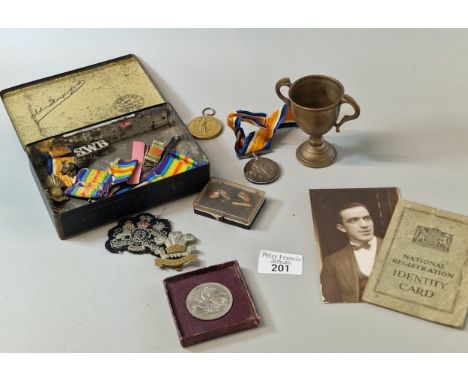  A box containing British WWI Medals awarded to Pte W. W. Jones (Royal Welsh Fusiliers), together with 'The Welch' cap badge,