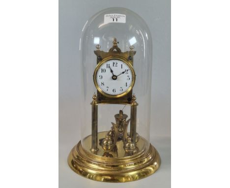 Early 20th century brass perpetual motion dome clock. 34cm high approx. (B.P. 21% + VAT)