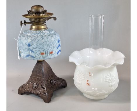 Early 20th century double oil burner lamp, having white opaline glass shade, above a marble glass reservoir, on cast metal ba