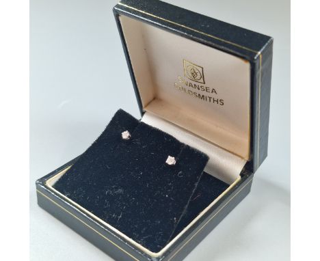 Pair of small diamond earrings, missing their backs. In Swansea Goldsmiths box.  (B.P. 21% + VAT)