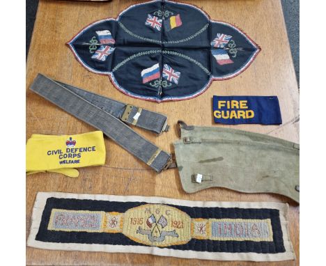 Tray containing a Machine Gun Corps table runner (1916-21), British and Allied Forces flags on runner, pair of webbing gaiter