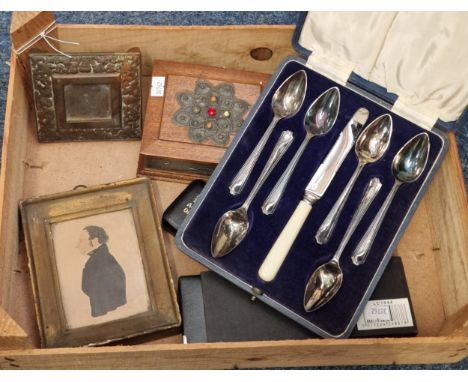 Box of oddments to include: cased silver plated spoons, brass inkwell stand, framed 19th century silhouette portrait, wooden 