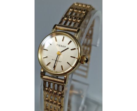 Tissot Stylist 9ct gold ladies wristwatch, with 9ct gold gate bracelet, having satin face, with Baton numerals. With original