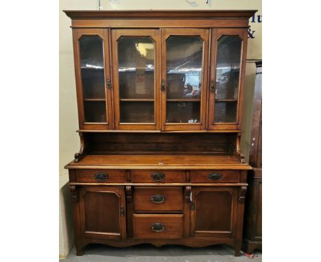Late Victorian oak cabinet backed dresser, the back with four doors and two fitted shelves, the base with an arrangement of f