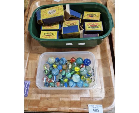Collection of Matchbox Series Moco Lesney diecast vehicles in original boxes, together with a plastic tub of vintage marbles.