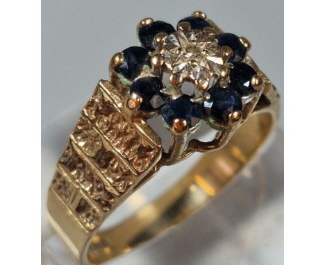 9ct gold diamond and sapphire flowerhead cluster ring, with engraved shoulders. 4g approx. Size P. (B.P. 21% + VAT)
