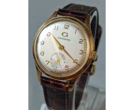 Garrard & Co Ltd, 9ct gold gentleman's mechanical wristwatch, with satin face, having Arabic numerals and seconds dial, on cr