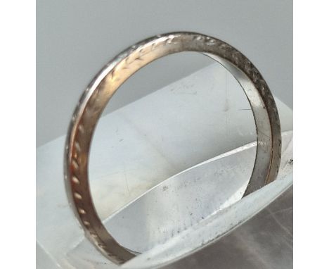 An engraved platinum wedding band. 2.8g approx. Size K. (B.P. 21% + VAT)
