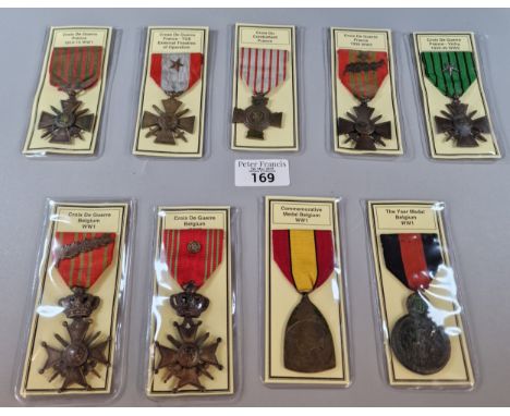 Folder containing nine (9) French and Belgian WWI and WWII medals to include: Belgium - The Yser Medal (WWI), commemorative M