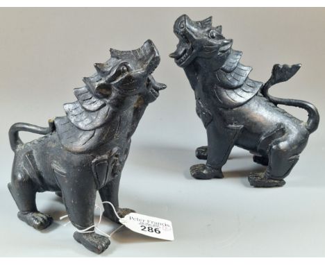 Pair of Chinese bronze guardian Lions/Foo Dogs. 15.5cm high approx. (2) (B.P. 21% + VAT) One is missing the top of its tail, 