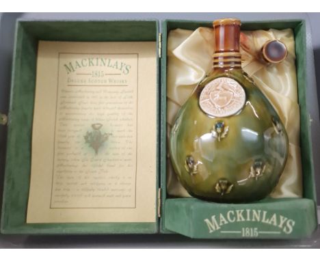 Mackinlays aged 20 years Deluxe Scotch Whisky, in Wade decanter and original box. (B.P. 21% + VAT)The seal is leaking.Box has