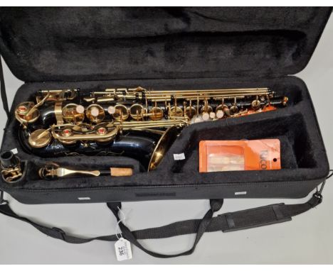 Modern Saxophone, in black and gilt lacquer. In original fitted case with accessories. (B.P. 21% + VAT)There is no make - in 