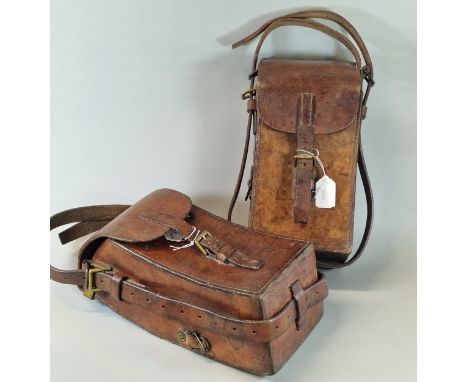 Two Madsen Light Machine Gun (LMG) curved pannier leather magazine / clip cases, with brass buckles and fixings. Height 33cm,