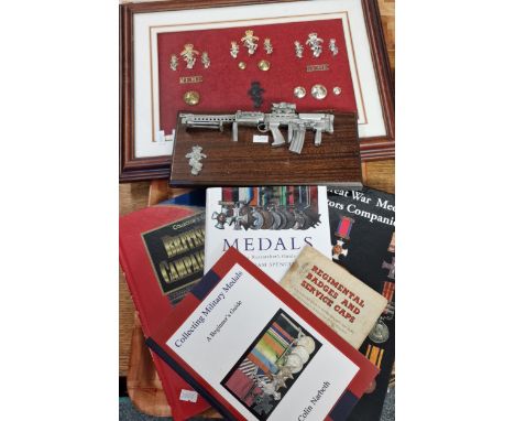 Tray consisting of framed and mounted collection of R.E.M.E. (Royal Electrical and Mechanical engineers) badges and buttons. 