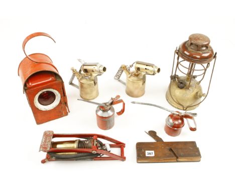 Two brass blow lamps, an early foot pump, two oilcans, a red lamp marked SGB and a part Tilly lamp G